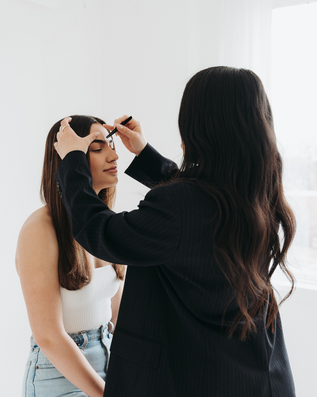 Brow Specialist Niki mapping client's brow